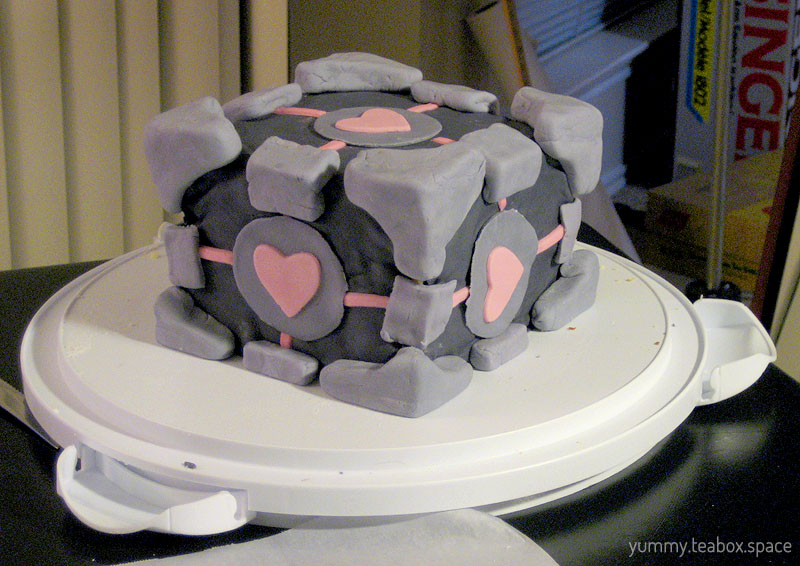 Cake covered in fondant that looks like the Companion Cube in the Portal games